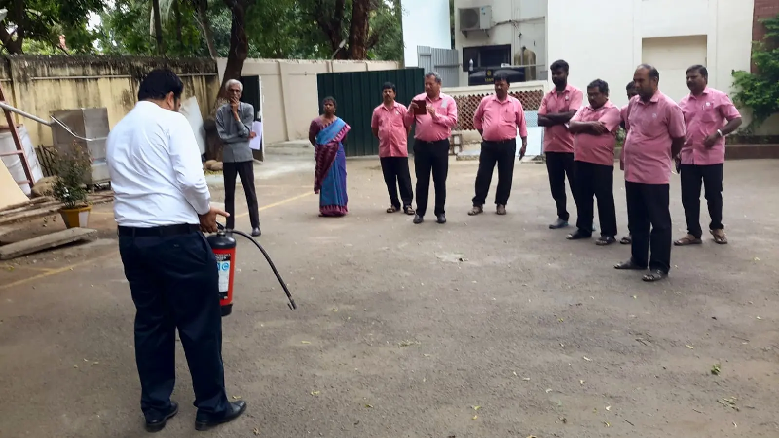 Showing staff how to hold and aim an extinguisher