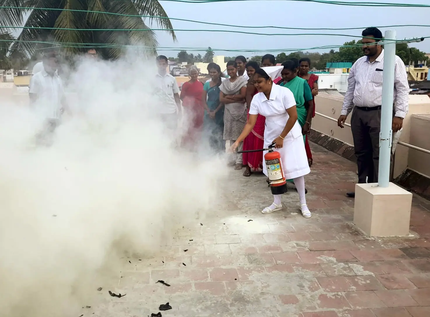 A nurse discharges an ABC extinguisher during staff training