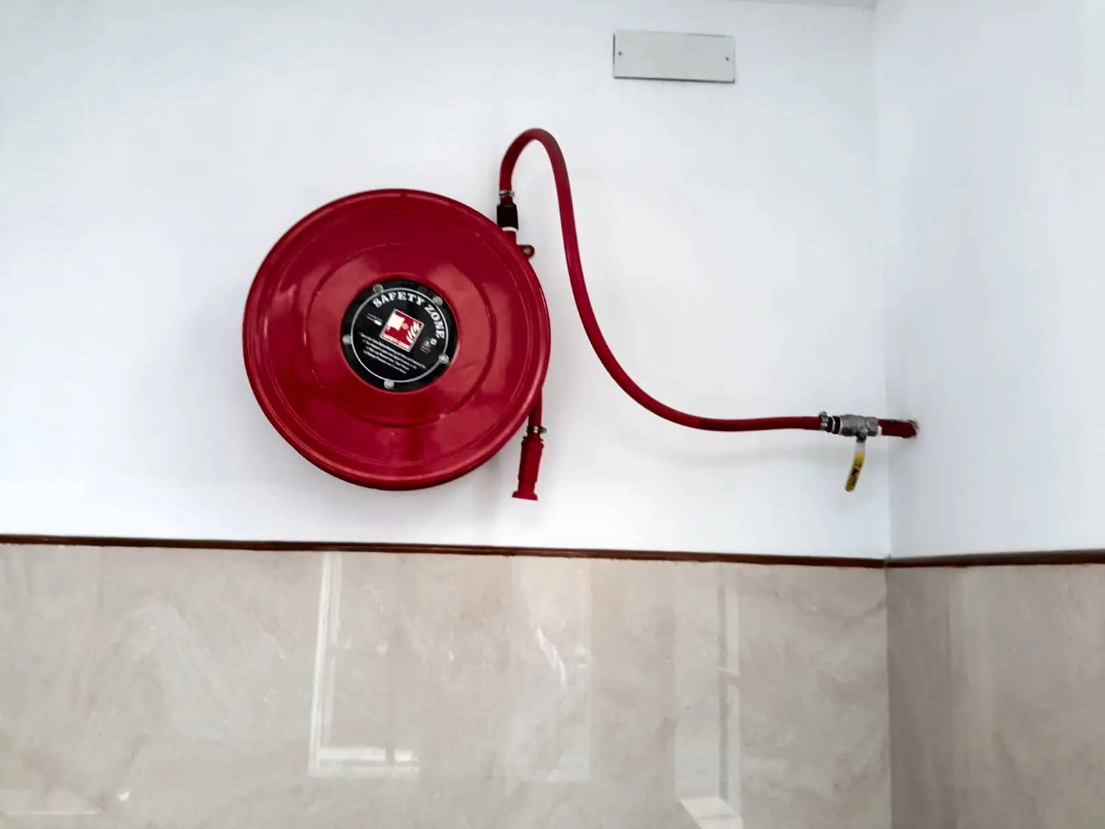 A wall-mounted hose reel