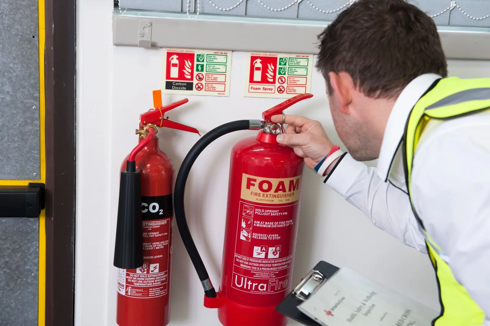 Fire marshal checking fire extinguishers