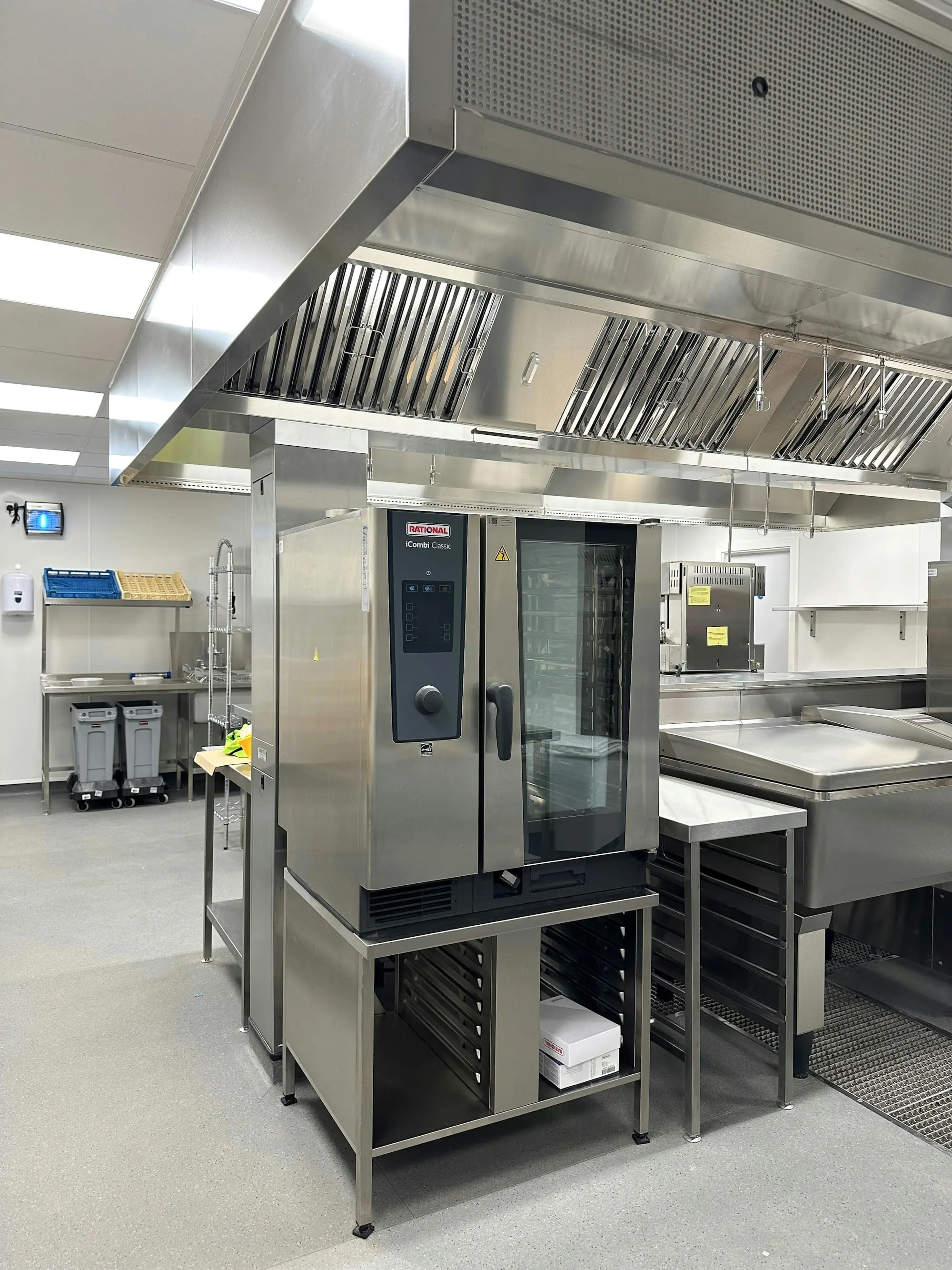 Commercial kitchen with an extraction hood over the cooking line